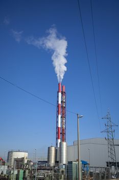 Heating plant - powerhouse and chimey with smoke make heat energy for city in winter