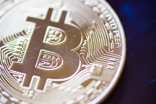 Bitcoin currency coin extreme closeup macro. Gold metal symbol