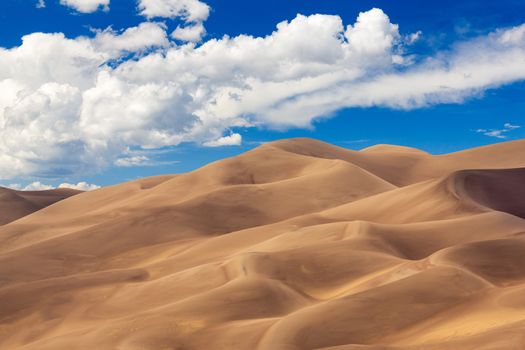 Detailed shot of the shadows on the dunes at Great Sand Dunes National Park in Colorado on a bright sunny but cloudy day