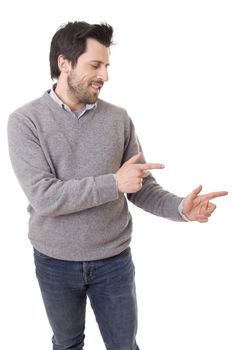 friendly young man pointing to his side and looking into the camera. isolated on white background