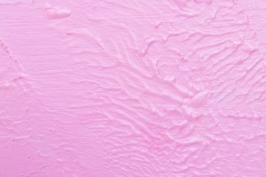 The texture of the rugged pink wall and structure background. Blurred uneven wall paint of watercolor on a wooden floor.