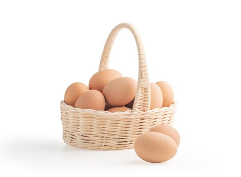 Eggs in the wicker basket isolated on the white backgrounds with clipping paths