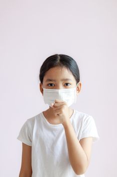 Portrait of Asian little girl wears a sanitary mask and coughs. The epidemic of the flu, Coronavirus or COVID-19 and illness with smog.