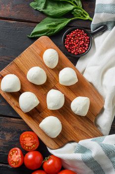 Fresh cherry tomatoes, basil leaf, mozzarella cheese on old wood background table .