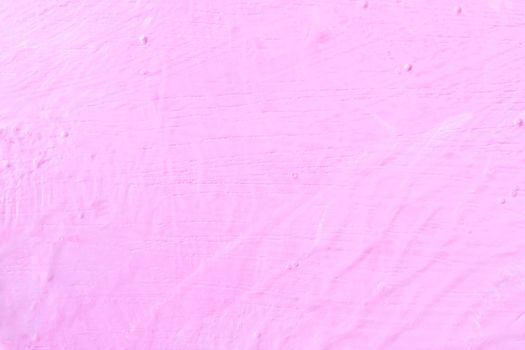 The texture of the rugged pink wall and structure background. Uneven wall paint.