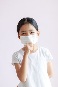 Portrait of Asian little girl wears a sanitary mask and cough. The epidemic of the flu, Coronavirus or COVID-19 and illness.