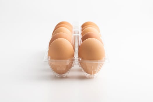 Eggs in a clear box on the white background.