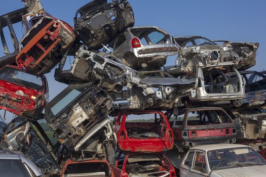 Damaged old cars on junkyard are waiting for recycling