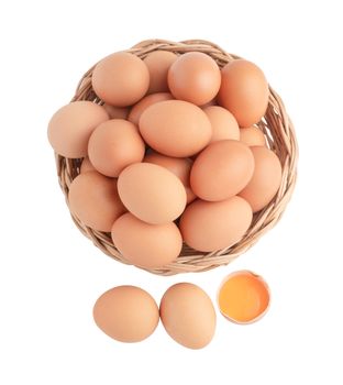 Top view chicken eggs in the wicker basket and one egg broken. Raw food isolated on the white background with clipping paths