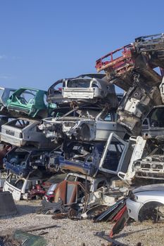 Damaged old cars on junkyard are waiting for recycling