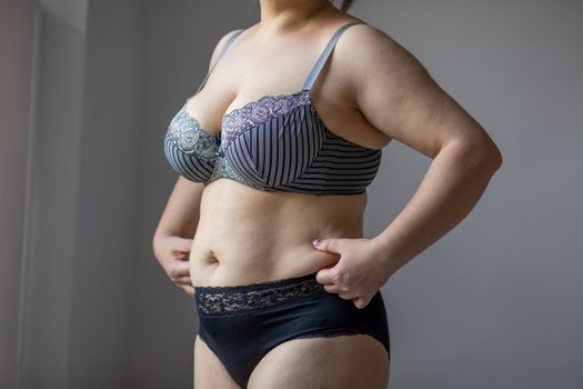 Woman Real Body Plus size Model in lingerie posign, imperfect nonideal