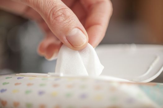 Hand picked a wet wipes in package box, Wet wipes in a woman's hand