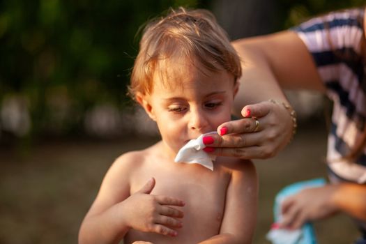 Hygiene - mom wiping the baby skin with wet wipes. Cleaning wipe, pure, clean, tissue, outdoor