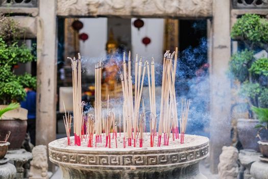 Incense sticks in ashes bucket in Temple Thialand
