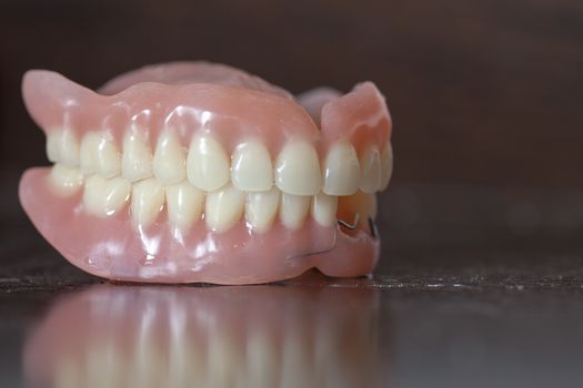 The artificial medical denture on black background