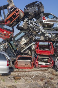 Big pil of old cars on junkyard are waiting for recycling