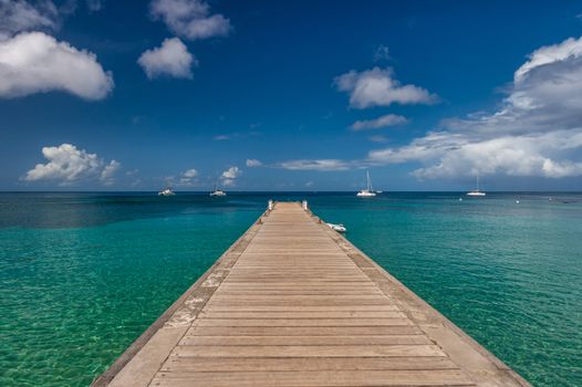 Wood pontoon and turquoise water at Petite Anse in Martinique