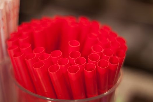 Red straws plastic drinking background, stock photo