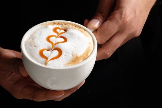 Capucino art coffee on wooden texture table