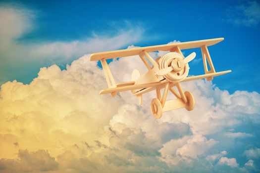 Wood airplane on the blue sky