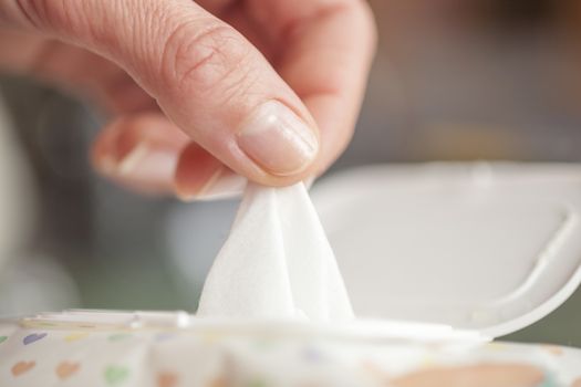 Hand picked a wet wipes in package box, Wet wipes in a woman's hand