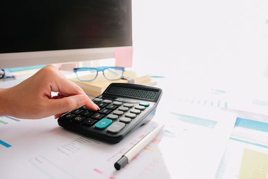 Close up of female accountant or banker making calculations. Savings, finance and economy concept.