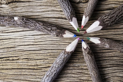 Teamwork concept of color pencil on wood background