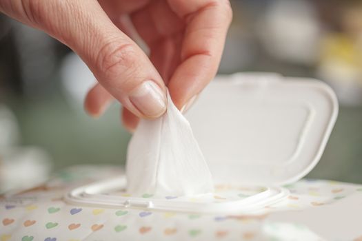 Hand picked a wet wipes in package box, Wet wipes in a woman's hand