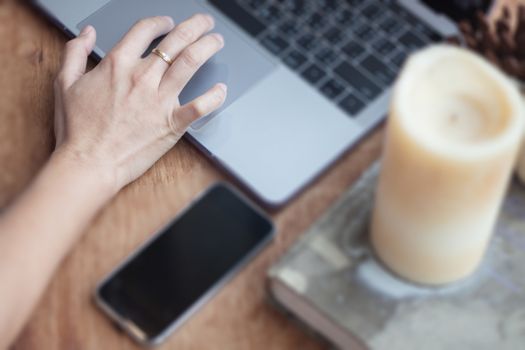 Woman working on computer in coffee shop, stock photo