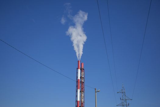 Heating plant - powerhouse and chimey with smoke make heat energy for city in winter