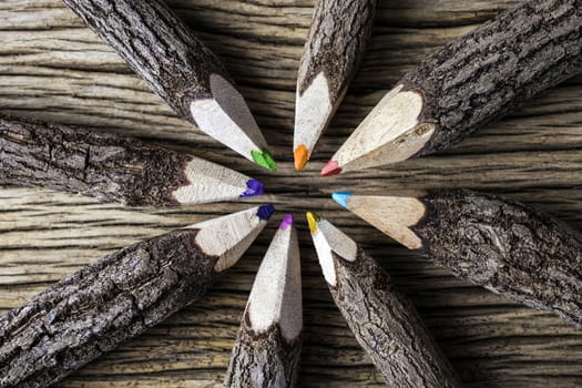 Teamwork concept of color pencil on wood background