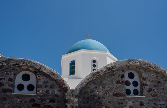 Traditional Greek Orthodox church with bell tower in village of Oia on Santorini