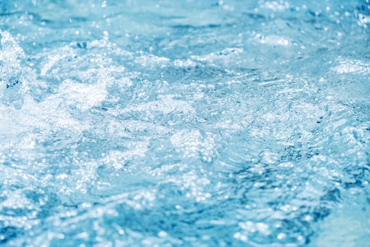 Water splash in swimming pool summer background