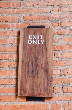 Exit only sign on brick wall, stock photo