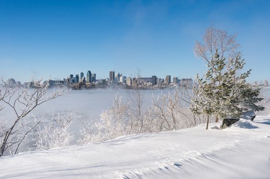 Montreal, CA - 1 January 2018: Montreal Skyline in winter as ice fog rises off the St. Lawrence River
