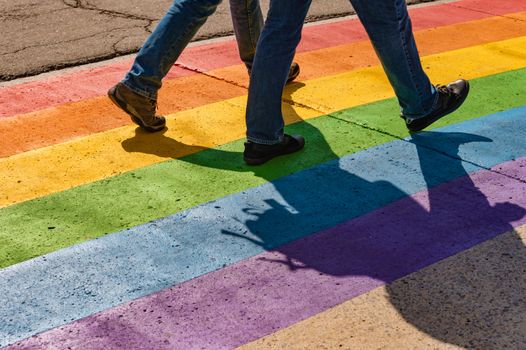 People walking on gay rainbow crosswalk in Montreal gay village