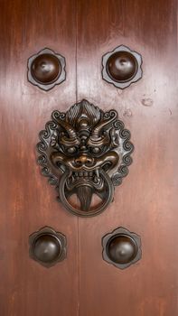 Solid wooden door with dragon head knocker