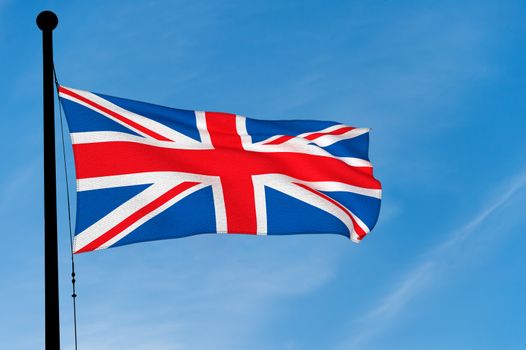 UK Flag waving over blue sky (3D rendering)
