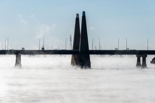 Montreal, CA - 1 January 2018: Pont de la Concorde as ice fog rises off the St. Lawrence River