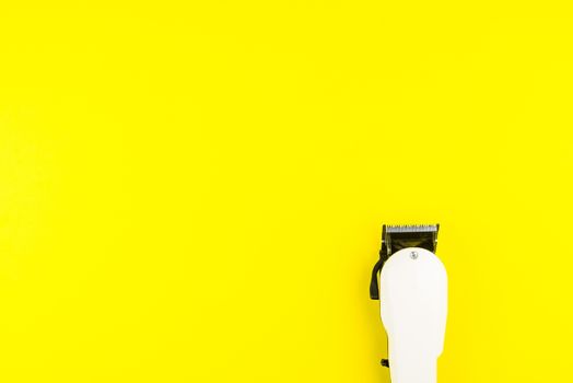 White electric clippers barber on yellow background. Hairdresser salon concept, Hairdressing Set. Haircut accessories. Copy space image, flat lay