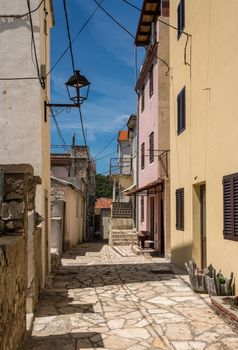 Narrow street with rustic houses and homes in the coastal town of Novigrad in Croatia
