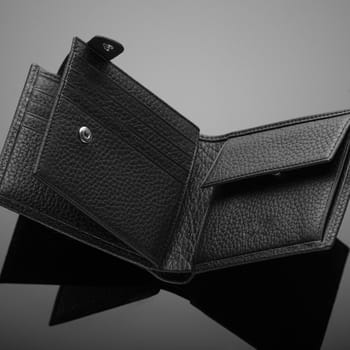 Fashionable designer leather men's wallet on a black background