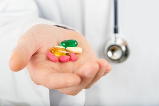 Hand of a doctor holding a drug pill