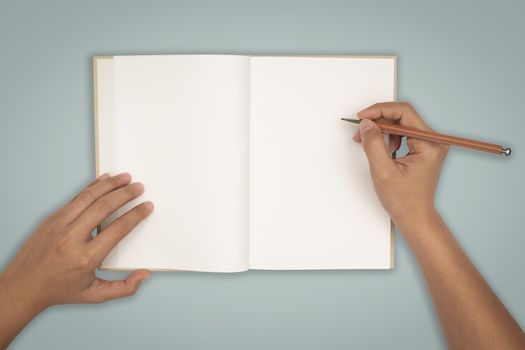 Top view- two hands hold a empty book spread.