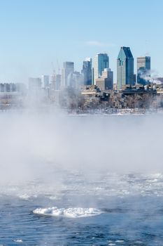 Montreal, CA - 1 January 2018: Montreal Skyline in winter as ice fog rises off the St. Lawrence River