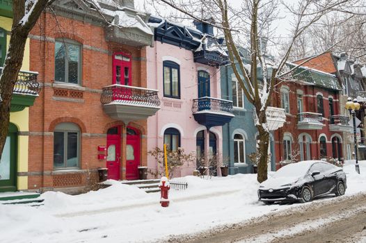 Row houses with colorful facades in the Plateau neighborhood in Montreal, in winter.