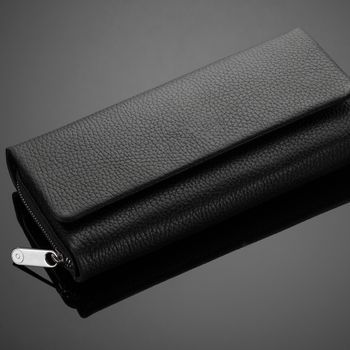 Fashionable leather men's wallet on a dark background