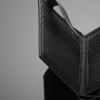 Fashionable designer leather men's wallet on a black background