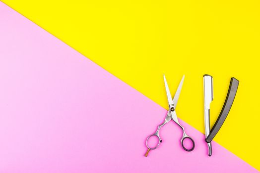 Stylish Professional Barber Scissors on yellow and pink background. Hairdresser salon concept, Hairdressing Set. Haircut accessories. Copy space image, flat lay