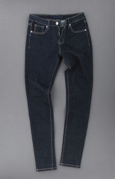 fashionable denim pants on grey background, top view